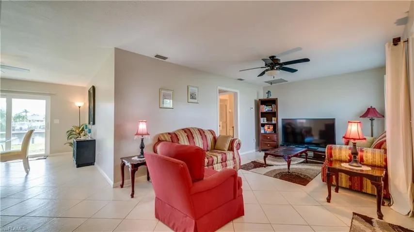 3830 View upon entry. Tiled living room with ceiling fan