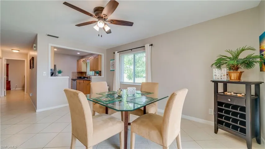 Tiled dining room featuring ceiling fan and sink