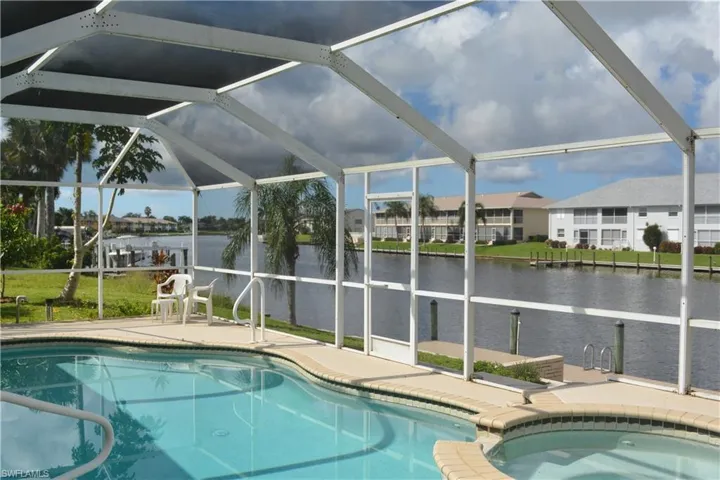 View of pool featuring a water view, a lanai, and a patio area