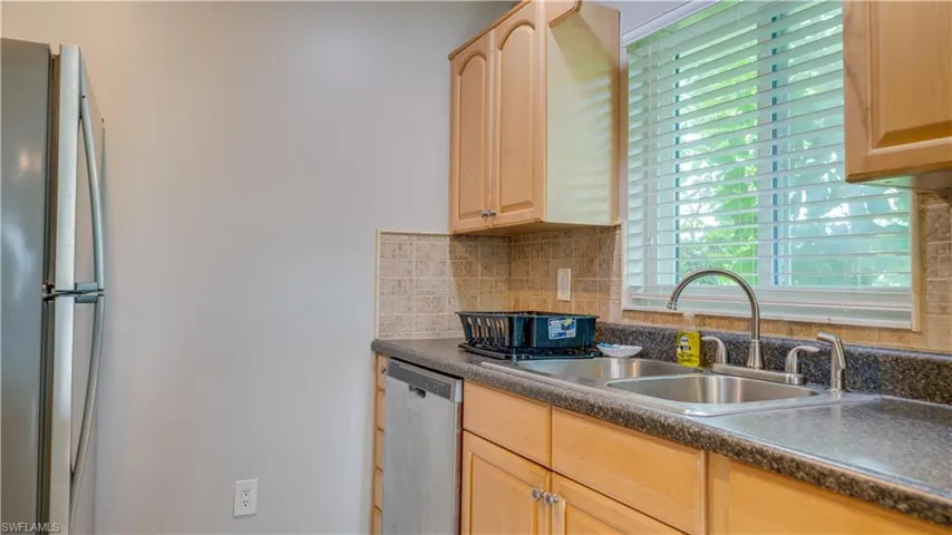 Kitchen with plenty of natural light, sink, stainless steel appliances, and light brown cabinets
