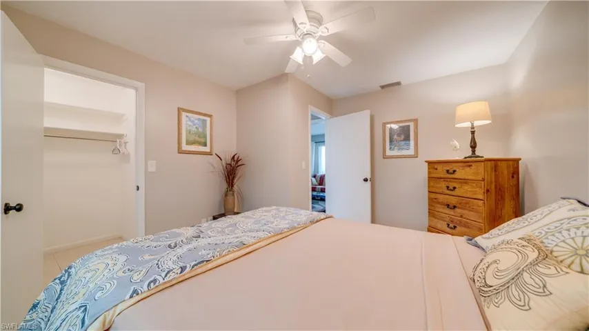 Tiled bedroom featuring a closet and ceiling fan