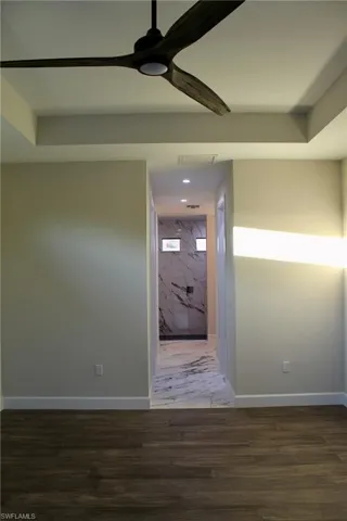 Hallway with dark wood-type flooring