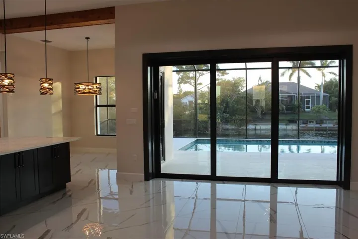 Doorway featuring beam ceiling