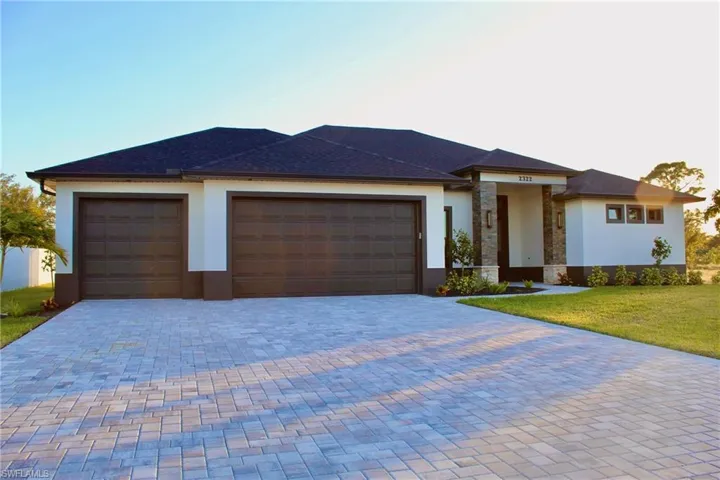 Prairie-style home with a garage and a front lawn