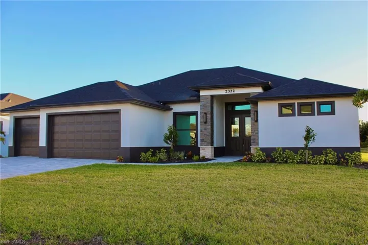 Prairie-style house featuring a front yard and a garage