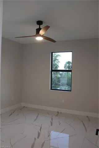 Empty room featuring ceiling fan