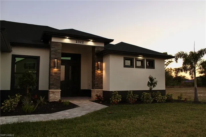 Prairie-style home featuring a yard