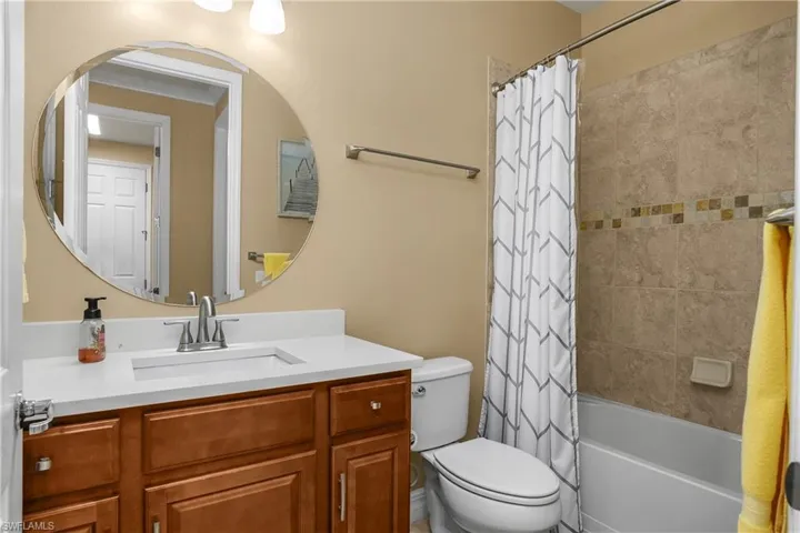 Full bathroom featuring vanity and shower / bath combo with shower curtain