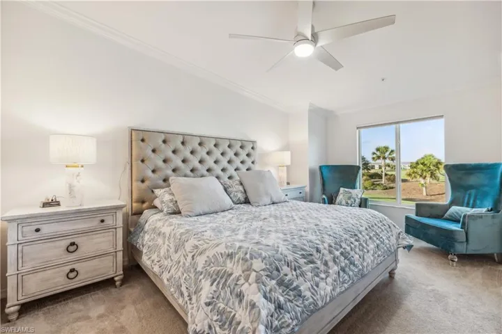 Bedroom featuring light carpet, ceiling fan, and crown molding