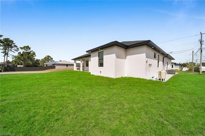 View of property exterior with stucco siding and a patio area