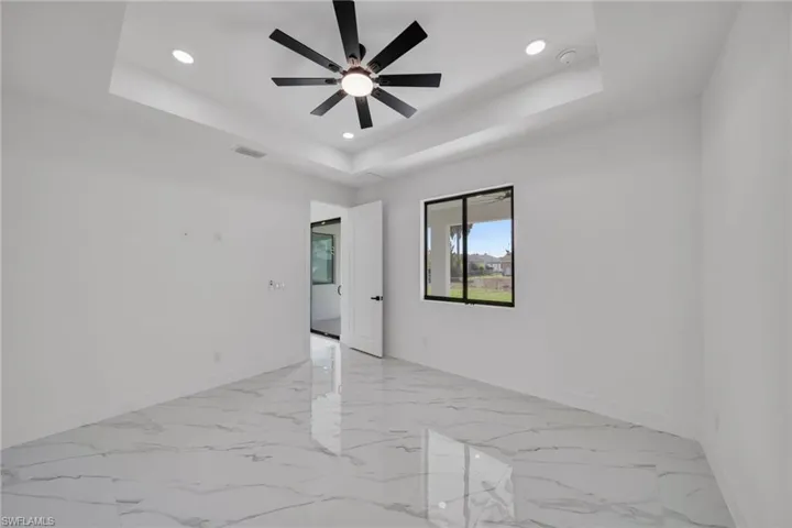 Unfurnished room featuring recessed lighting, light marble finish floors, and ceiling fan