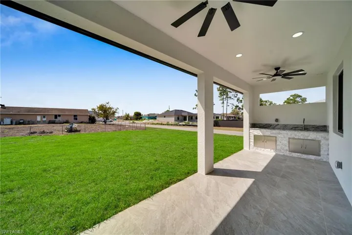 Fenced yard featuring a patio, area for grilling, and ceiling fan