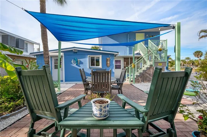 View of patio with stairway and outdoor dining area