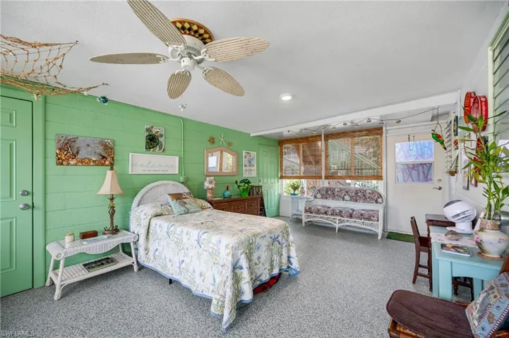 Bedroom with ceiling fan and multiple windows