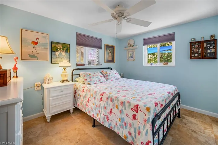 Bedroom featuring multiple windows and a ceiling fan