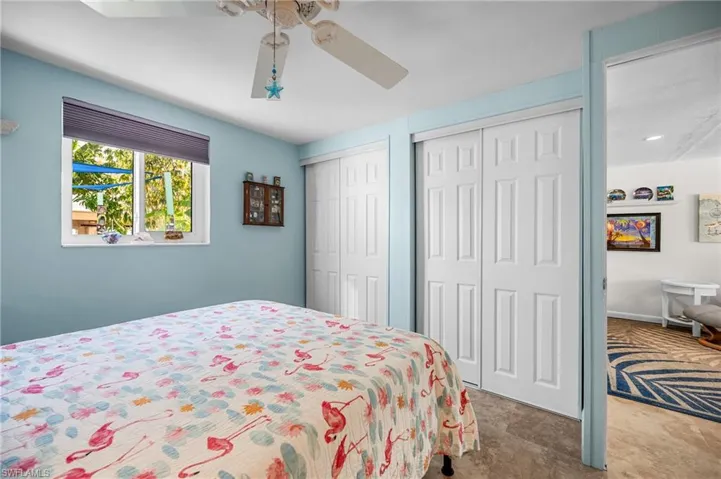 Bedroom with two closets and ceiling fan