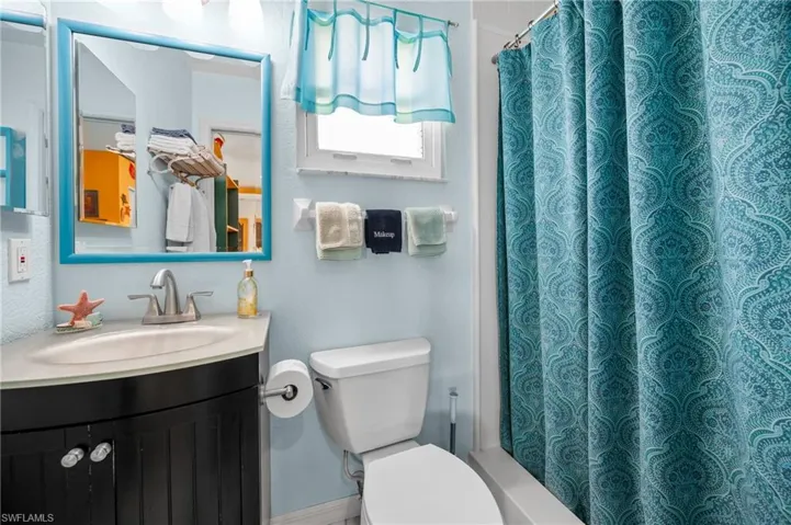 Full bath featuring vanity and toilet
