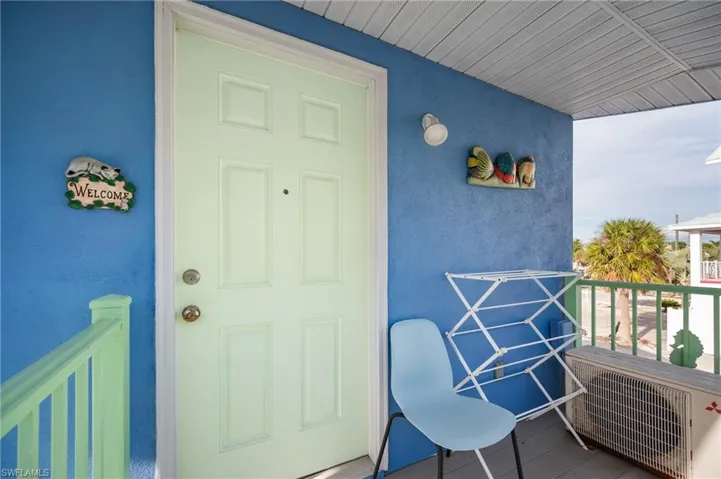 Doorway to property featuring stucco siding