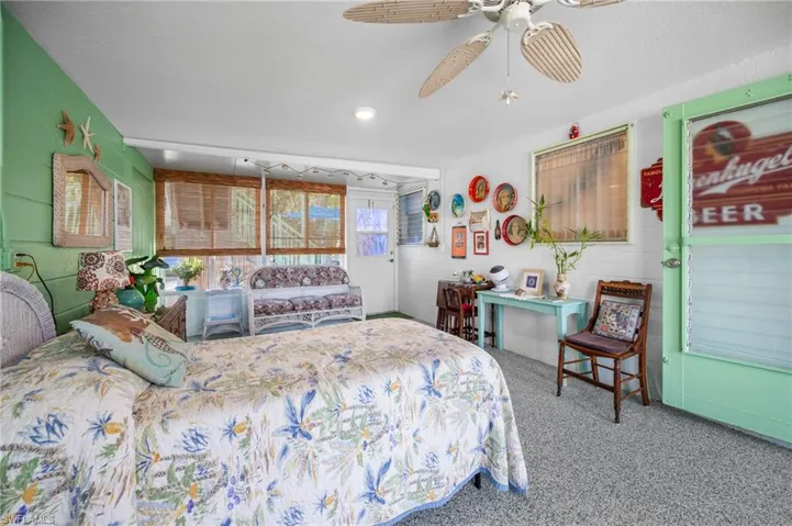 Carpeted bedroom with a ceiling fan