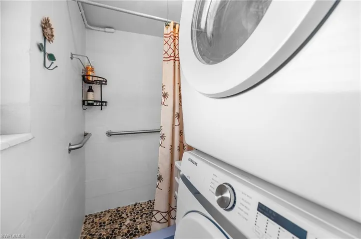 Laundry area featuring stacked washer / dryer