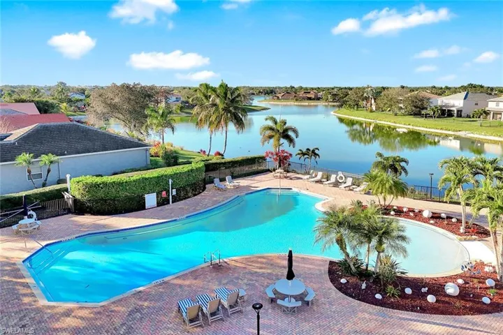 Community pool featuring a patio and a water view