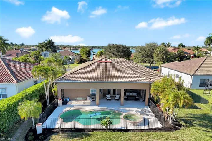 Rear view of property with a patio area, stucco siding, a fenced backyard, and a residential view
