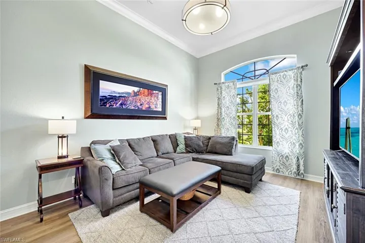 Living area featuring light wood finished floors and ornamental molding
