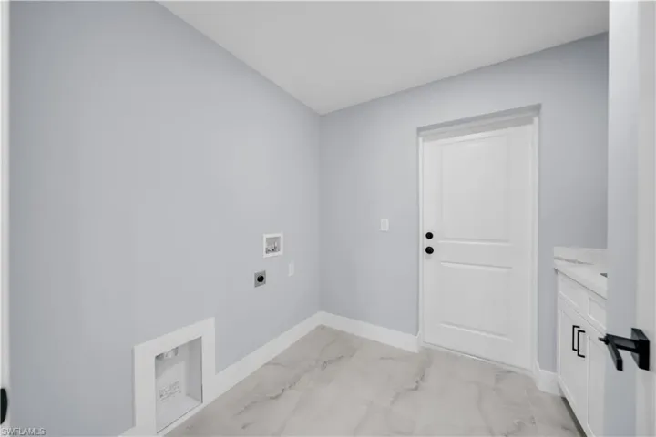 Washroom with light marble finish flooring, washer hookup, and electric dryer hookup