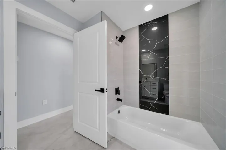 Bathroom featuring shower / tub combination and recessed lighting