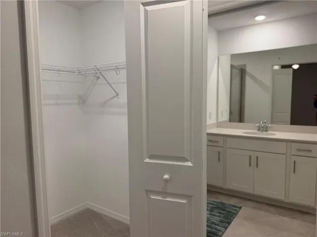 Closet leading to primary bathroom