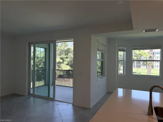 View of open space between living room, kitchen and dining room leading to the lanai.