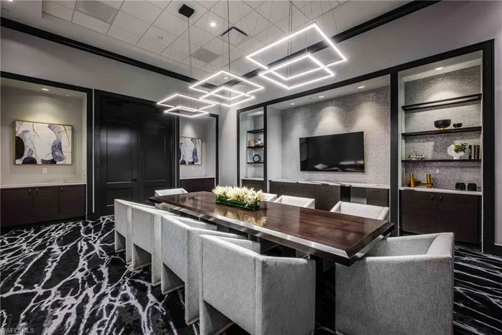 Cinema room featuring built in shelves, wainscoting, and recessed lighting