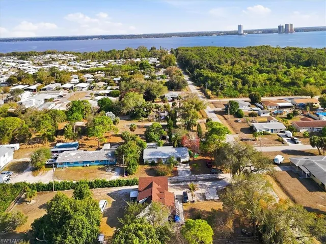 Aerial view of residential area featuring a nearby body of water