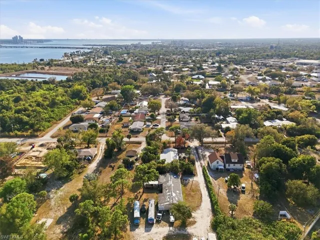 Aerial perspective of suburban area featuring a large body of water