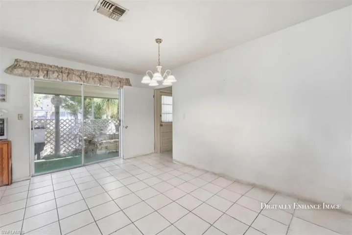 Unfurnished dining area featuring a chandelier and tile patterned flooring