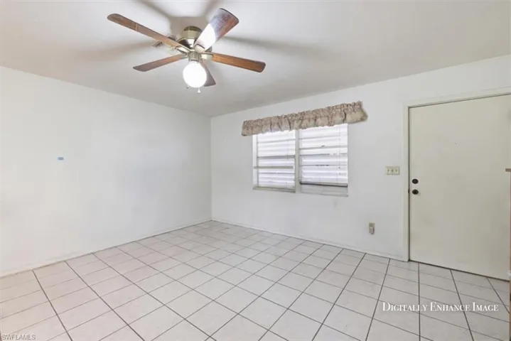 Spare room with a ceiling fan and light tile patterned flooring
