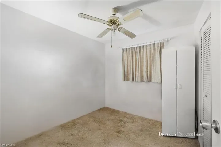 Spare room featuring carpet and a ceiling fan
