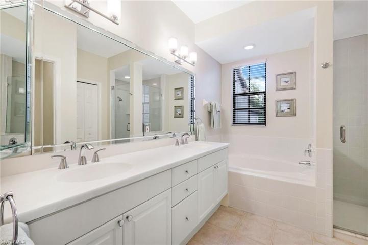 En suite primary bath with dual sinks, soaking tub and walk in shower.