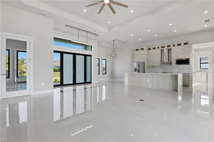 looking at kitchen and entrance door, and bedroom/den to the left