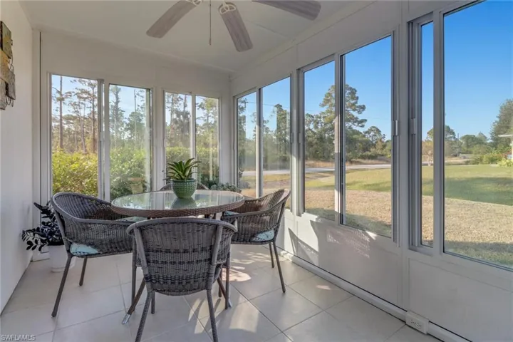 Sunroom with baseboard heating and ceiling fan