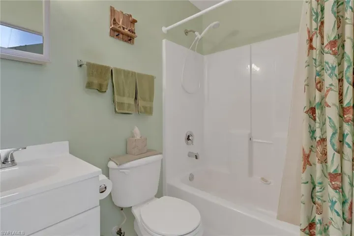 Full bathroom featuring toilet, shower / tub combo, and vanity