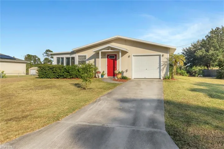 Ranch-style home with a garage and a front yard