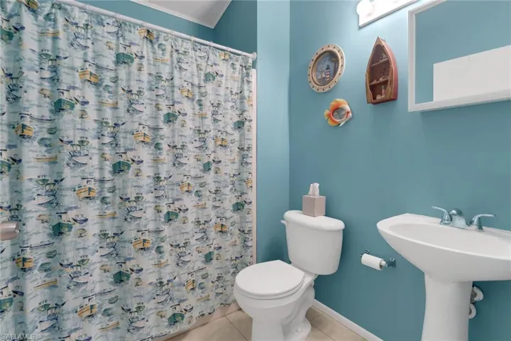 Bathroom with sink, tile patterned floors, and toilet