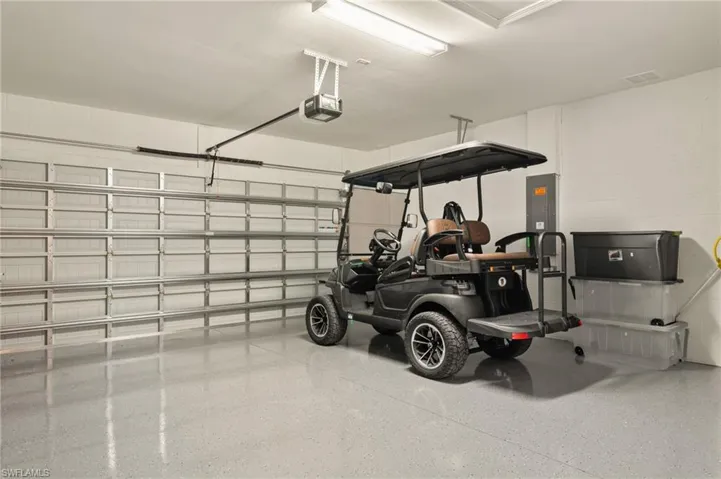 Garage featuring epoxy flooring and a garage door opener