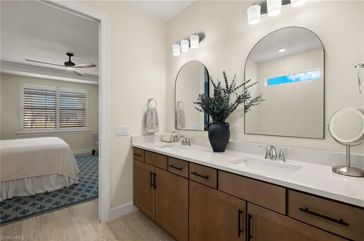 Bathroom with ceiling fan, wood-type tile flooring, and vanity
