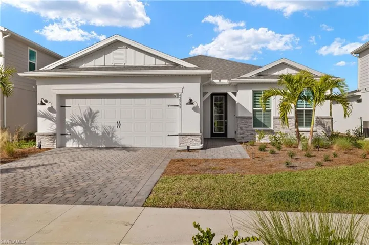 View of front of house with a front lawn and a garage