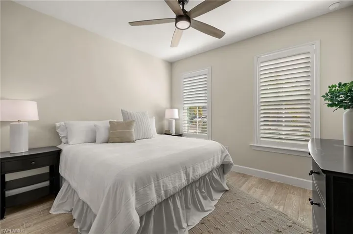Bedroom with light wood-style tile floors and ceiling fan