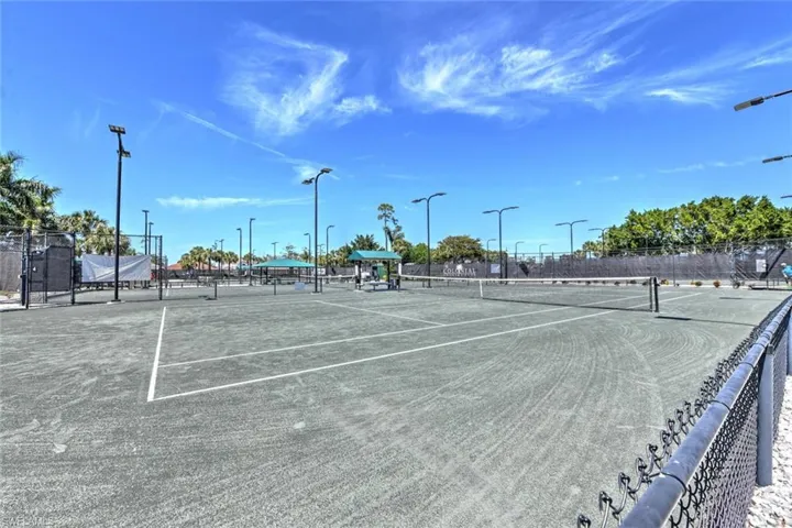 View of tennis court featuring fence