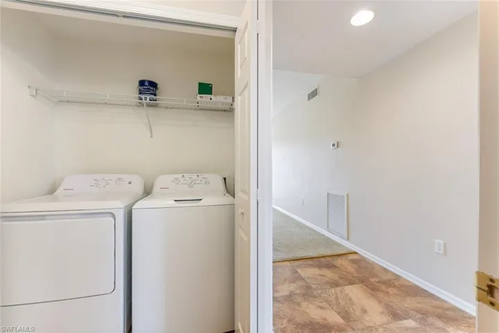 Laundry room featuring baseboards, visible vents, laundry area, and washer and clothes dryer