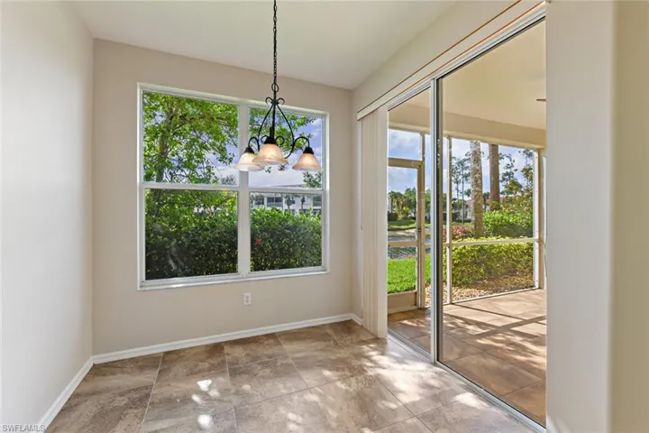 Unfurnished dining area featuring baseboards and an inviting chandelier